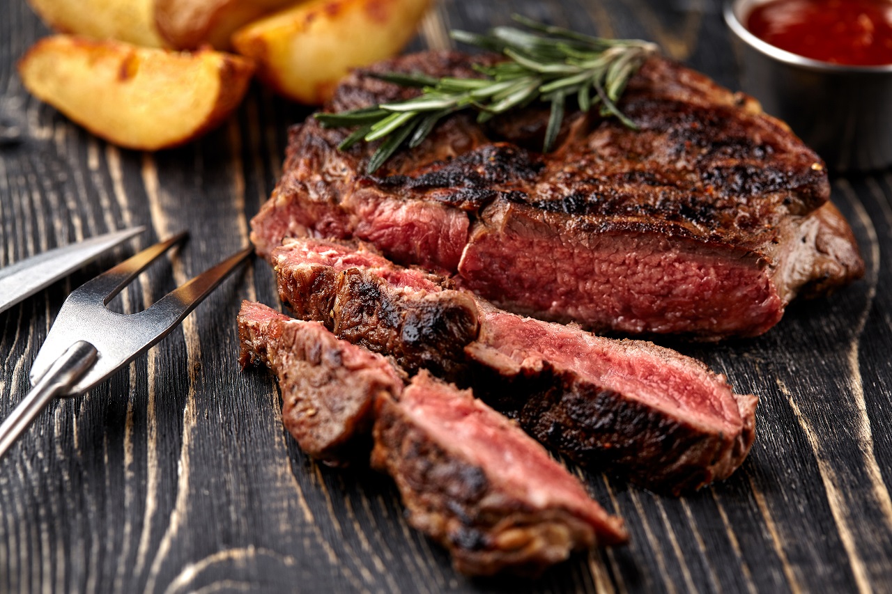 Juisteak-medium-rare-beef-with-spices-on-wooden-board-on-table