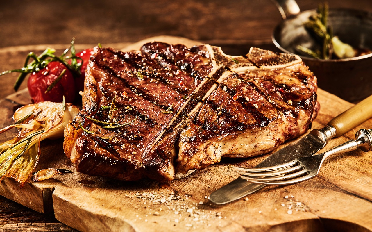 Succulent-grilled-large-t-bone-steak-garnished-with-herbs