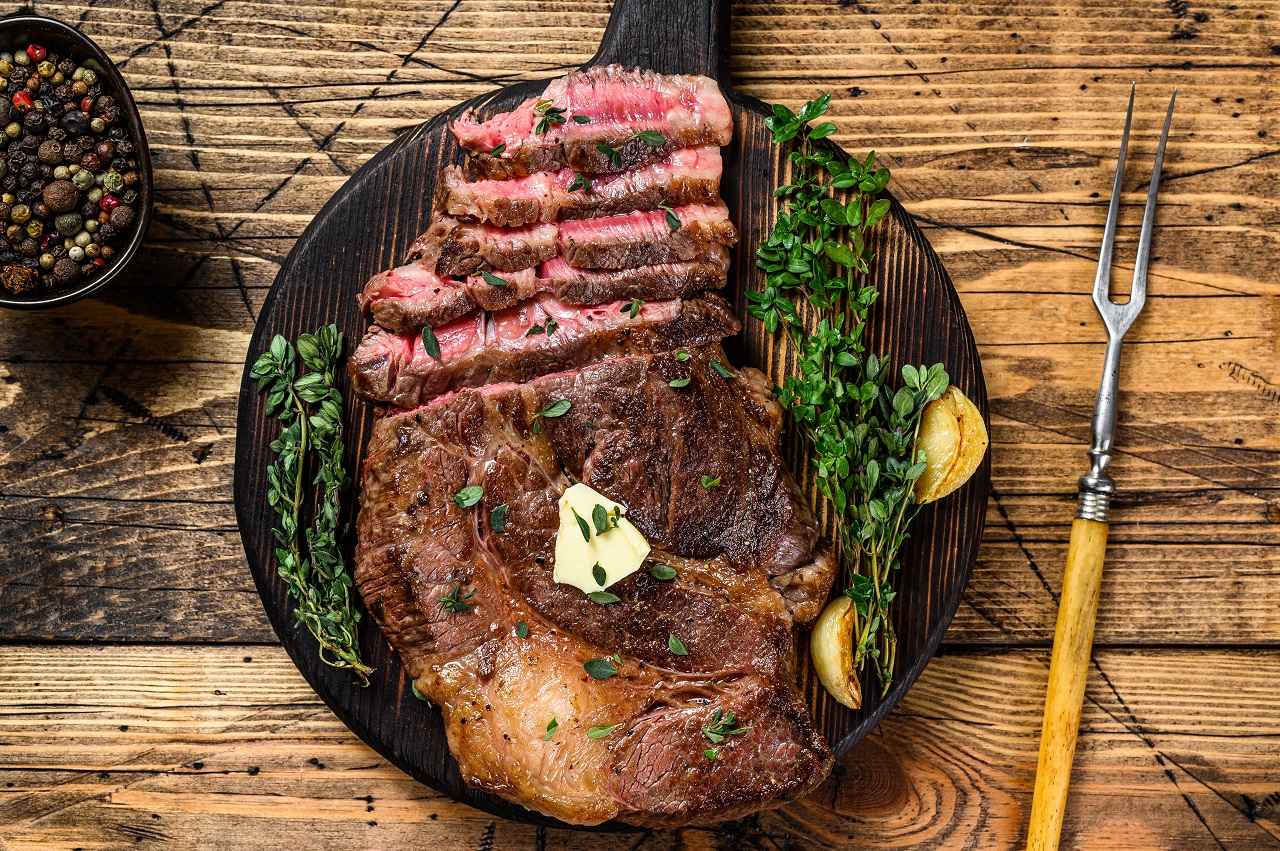 Roast-rib-eye-beef-meat-steak-on-a-cutting-board